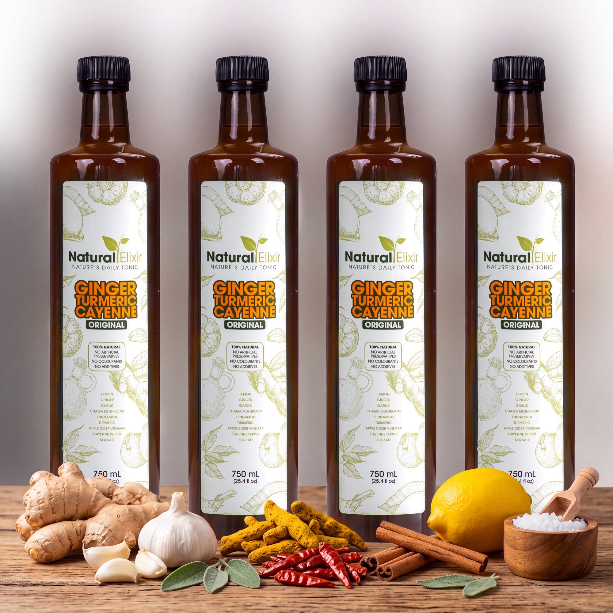 Four bottles of Natural Elixir Classic health tonic on a wooden counter with fresh ginger, garlic, turmeric, chillies, lemon, cinnamon and sea salt